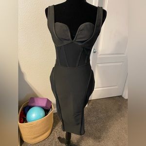 Unique, sexy little black dress. Size medium, new with tags